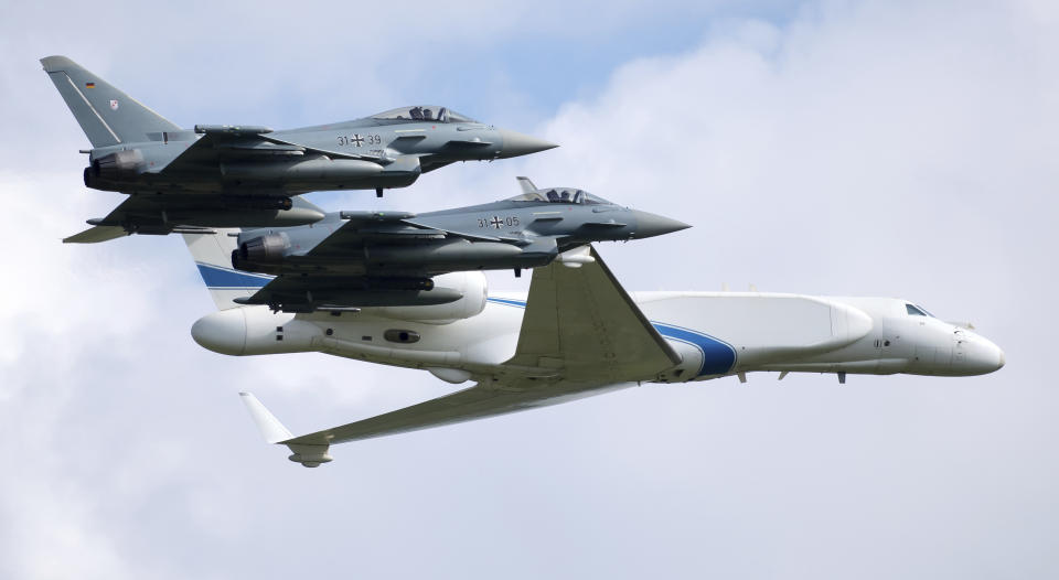 Two German air force Bundeswehr Eurofighters and an Israeli Air Force jet fly in formation over the Fuerstenfeldbruck airbase in commemoration of the 1972 Olympic Games assassination attempt in Fuerstenfeldbruck, Germany, Tuesday, Aug. 18, 2020. The attempt to rescue the hostages failed at the airbase in Fuerstenfeldbruck in 1972and the hostages perished. It is the Israeli Air Force's first time conducting joint air combat exercises in Germany. (Sven Hoppe/dpa via AP)