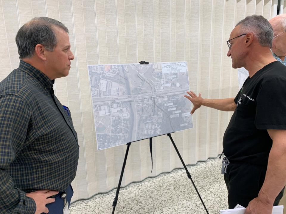 Dr. Bill Mallon, who owns an eye center and Big Shots Golf on U.S. 1, speaks with Victor Ramos, of the Florida Department of Transportation, during a meeting Wednesday Feb. 8, 2023, at the Vero Beach Community Center. William Evans with WGI, an engineering contractor for FDOT, presented six alternatives, including an underpass and overpasses, to relieve traffic at U.S. 1 and Aviation Boulevard in Vero Beach.