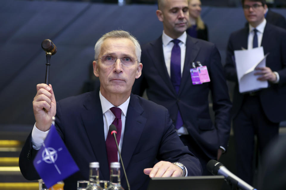NATO Secretary General Jens Stoltenberg bangs a gavel to signify the start of a meeting of the NATO-Ukraine Council at NATO headquarters in Brussels, Thursday, April 4, 2024. NATO celebrates on Thursday 75 years of collective defense across Europe and North America as Russia's war on Ukraine enters its third year. (Johanna Geron, Pool Photo via AP)