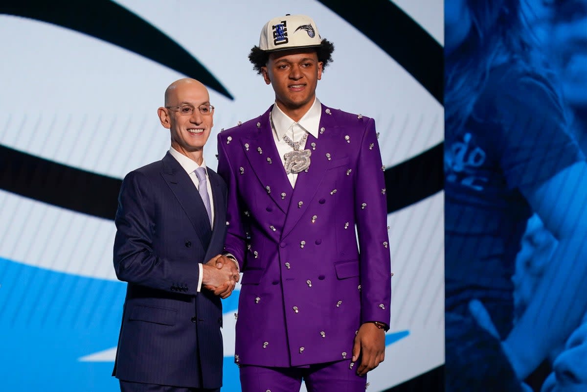 Paolo Banchero, right, with NBA commissioner Adam Silver after being selected as the number one pick overall by the Orlando Magic in the NBA Draft (John Minchillo/AP/PA) (AP)