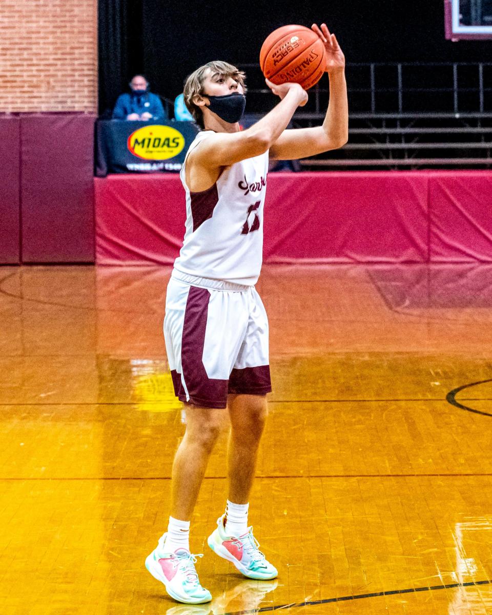 Bishop Stang's Frank Vollaro attempts a three-point shot.