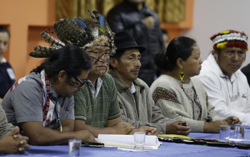 Indigenous leaders attend negotiations with President Lenin Moreno in Quito, Ecuador, Sunday, Oct. 13, 2019. The government and indigenous protesters started negotiations aimed at defusing more than a week of demonstrations that have paralyzed the nation's economy. (AP Photo/Fernando Vergara)