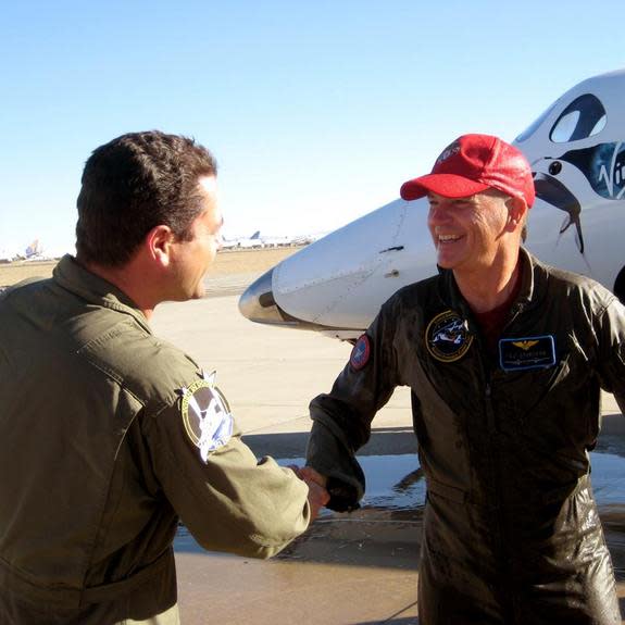 Former NASA space shuttle commader Rick "CJ" Sturckow smiles and shakes hands after flying Virgin Galactic's SpaceShipTwo to a landing at California's Mojave Air and Space Port after a glide test flight on Jan. 17, 2014.