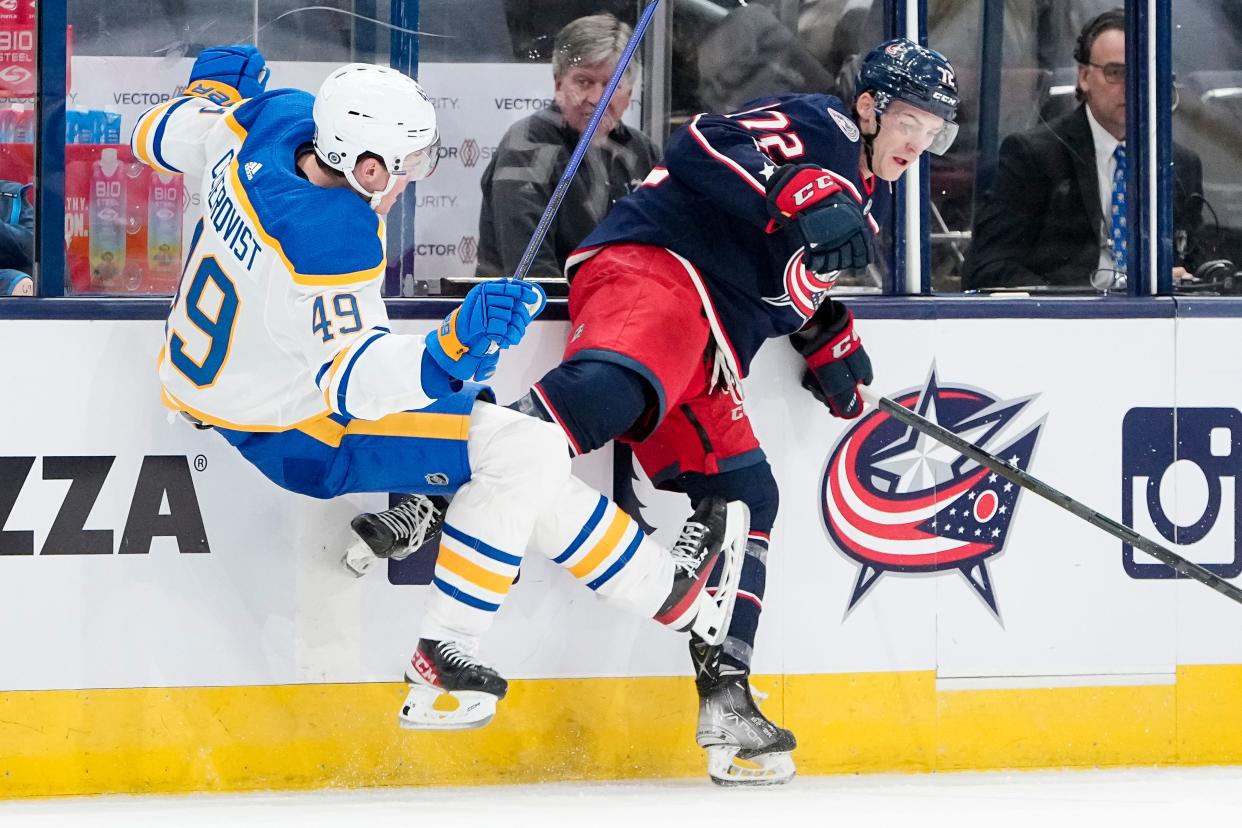 Sep 28, 2022; Columbus, Ohio, USA;  Columbus Blue Jackets forward Carson Meyer (72) hits Buffalo Sabres left wing Filip Cederqvist (49) during the first period of the NHL preseason hockey game at Nationwide Arena. Mandatory Credit: Adam Cairns-The Columbus Dispatch