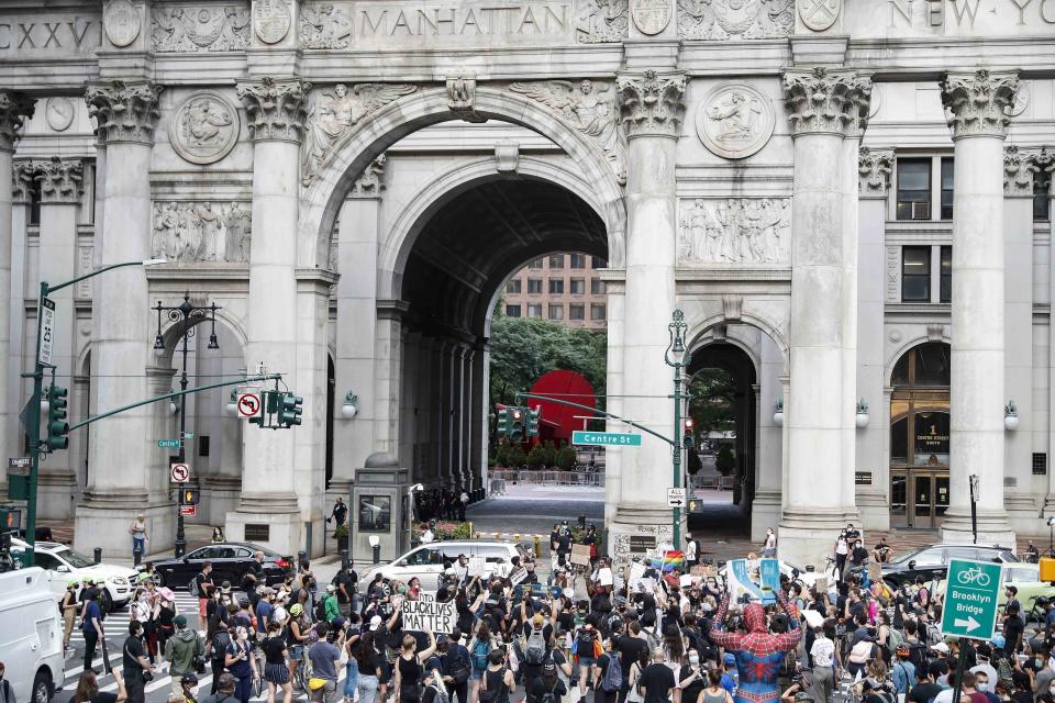 Protesters gather at an encampment outside City Hall, Tuesday, June 30, 2020, in New York. New York City lawmakers are holding a high-stakes debate on the city budget as activists demand a $1 billion shift from policing to social services and the city grapples with multibillion-dollar losses because of the coronavirus pandemic. (AP Photo/John Minchillo)