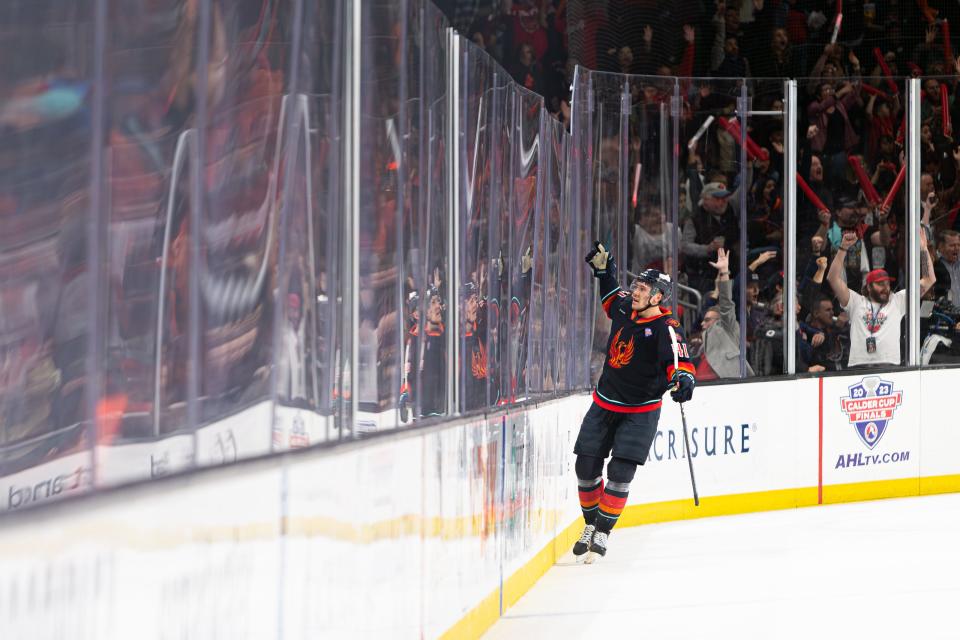 Ryker Evans (#41) acknowledges the crowd with a triumphant salute after scoring a goal during the AHL Calder Cup Finals game between the Coachella Valley Firebirds and the Hershey Bears at Acrisure Arena in Palm Desert, CA on June 10, 2023.