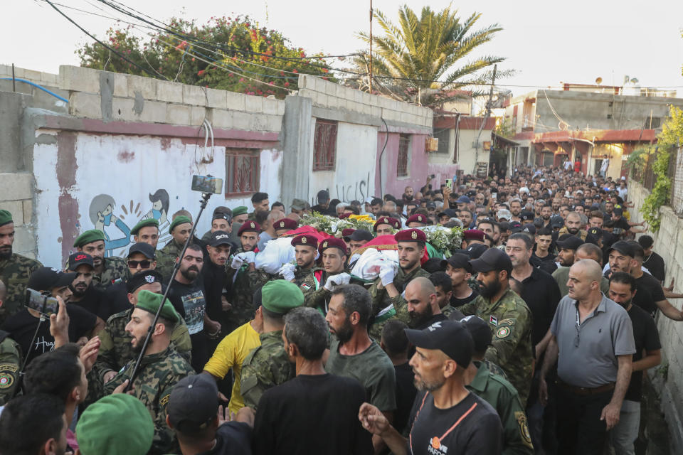 Members of the Palestinian Fatah Movement carry the body of Abu Ashraf al-Armoushi, the Palestinian National Security Commander in the Saida region and his commender, during their funeral procession at Rashidiyeh Palestinian refugee camp, southern Lebanon, Monday, July 31, 2023. (AP Photo/Mohammad Zaatari)