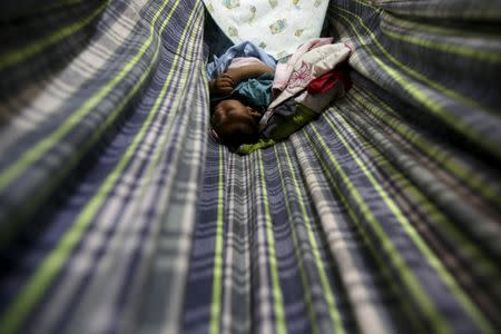 Lucas, 4-months old, who is Miriam Araujos's second child and born with microcephaly, sleeps on a hammock at their house, in Sao Jose dos Cordeiros, Brazil early February 17, 2016. REUTERS/Ricardo Moraes