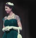 <p>The Queen wore an emerald dress and white gloves on the balcony of Melbourne's Government House during her 1954 tour of Australia.</p>