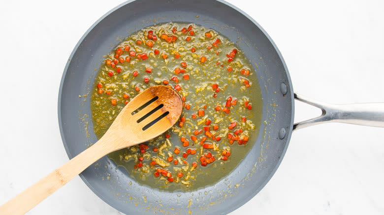 garlic, chile, and lemon zest frying in pan