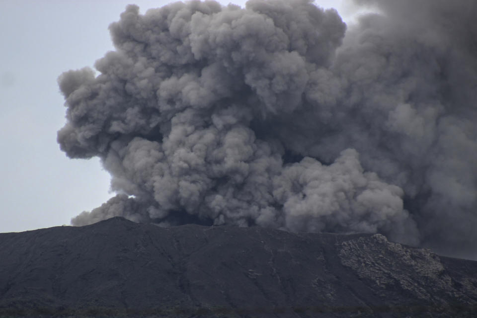 Mount Marapi spews volcanic ash into the air in Agam, West Sumatra, Indonesia, Wednesday, Dec. 6, 2023. Rescuers were searching for a female hiker who was caught by a surprise weekend eruption of the volcano that killed nearly two dozens climbers and injured several others, officials said Wednesday. (AP Photo/Ade Yuandha)