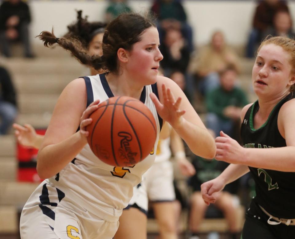 Copley's Shelby Emich takes the ball down court after a grabbing a rebound as Highland's Kennedy Morgan defends during a game earlier this season.