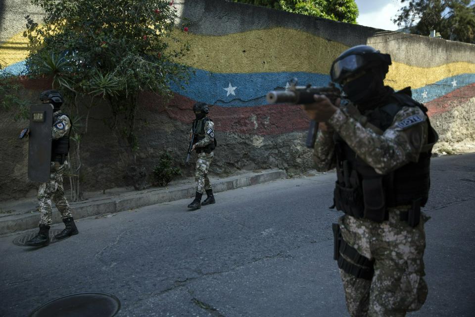 Members the National Police Action Force, or FAES, an elite commando unit created for anti-gang operations, patrol the Antimano neighborhood of Caracas, Venezuela, Tuesday, Jan. 29, 2019. PROVEA, the rights group Venezuelan Education-Action Program on Human rights, released a report in January accusing the unit of involvement in more than 200 killings in 2018. (AP Photo/Rodrigo Abd)