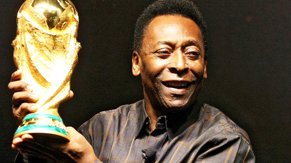 Pele, pictured here with the FIFA World Cup trophy during a presentation in Brazil.