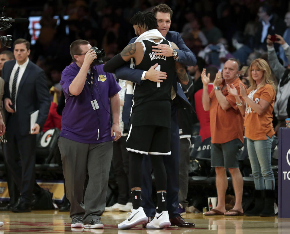 Lakers coach Luke Walton gave Nets guard D’Angelo Russell a hug during Russell’s return to L.A. earlier this month. (AP)