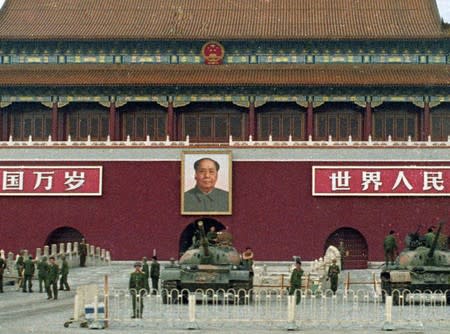 Chinese People's Liberation Army soldiers and tanks guard the Gate of heavenly Peace and the portrait of Chairman Mao in Tiananmen Square