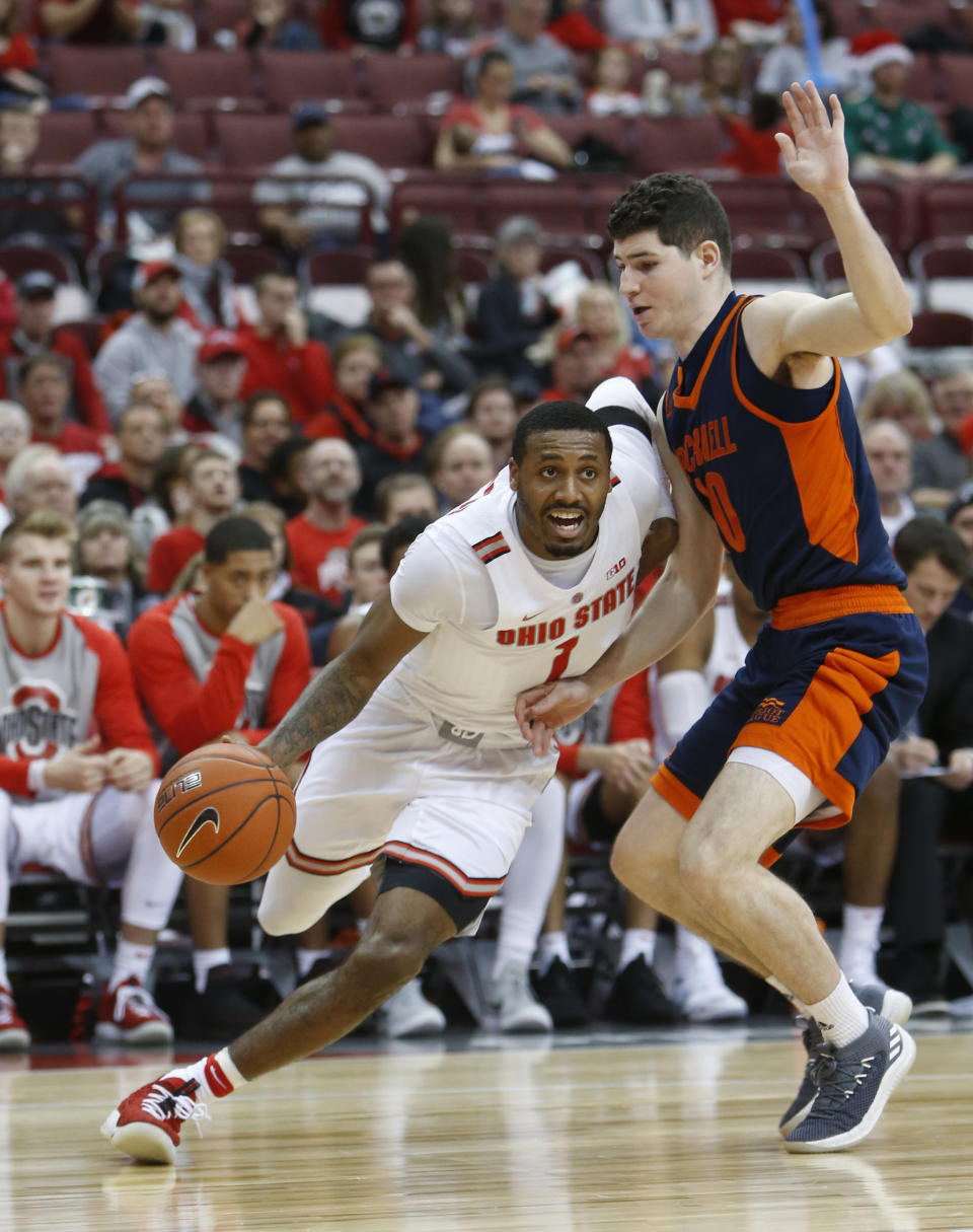 Ohio State's Luther Muhammad, left, drives the baseline as Bucknell's Andrew Funk defends during the second half of an NCAA college basketball game Saturday, Dec. 15, 2018, in Columbus, Ohio. Ohio State beat Bucknell 73-71. (AP Photo/Jay LaPrete)