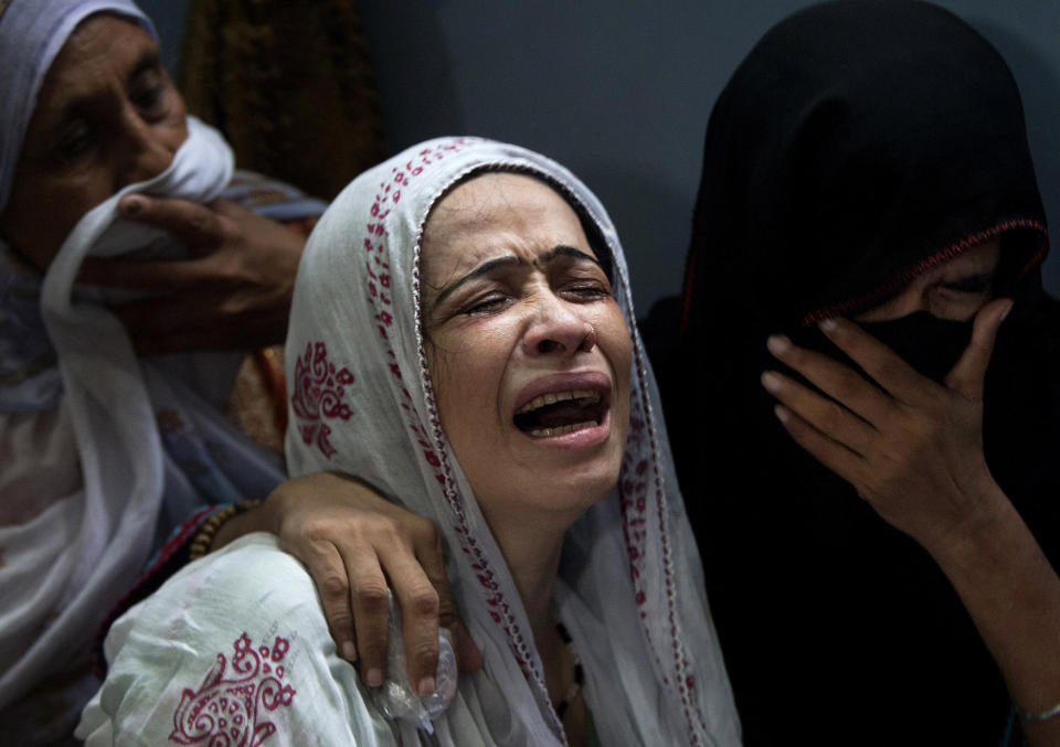 <p>A Pakistani mother, center, mourns over the death of her son who was killed in a bomb explosion, in Karachi, Pakistan, Aug. 7, 2013. (AP Photo/Shakil Adil) </p>