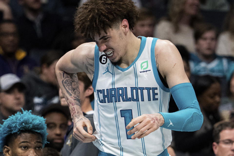 Charlotte Hornets guard LaMelo Ball reacts after being shaken up on a play during the second half of the team's NBA basketball game against the Indiana Pacers in Charlotte, N.C., Wednesday, Nov. 16, 2022. (AP Photo/Jacob Kupferman)