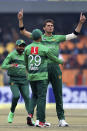 Pakistan pacer Shaheeh Shah Afridri, center, celebrates with teammates after taking the wicket of Bangladesh batsman Mohammad Naim during the second T20 cricket match at Gaddafi stadium, in Lahore, Pakistan, Saturday, Jan. 25, 2020. (AP Photo/K.M. Chaudary)