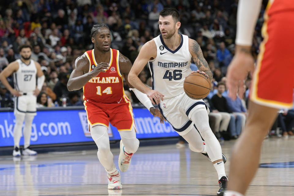 Memphis Grizzlies guard John Konchar (46) handles the ball ahead of Atlanta Hawks forward AJ Griffin (14) in the second half of an NBA basketball game, Monday, Dec. 12, 2022, in Memphis, Tenn. (AP Photo/Brandon Dill)