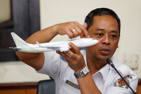 Indonesia’s National Transportation Safety Committee (KNKT) sub-committee head for air accidents, Nurcahyo Utomo, holds a model airplane while speaking during a news conference on its investigation into a Lion Air plane crash last month, in Jakarta, Indonesia November 28, 2018. REUTERS/Darren Whiteside