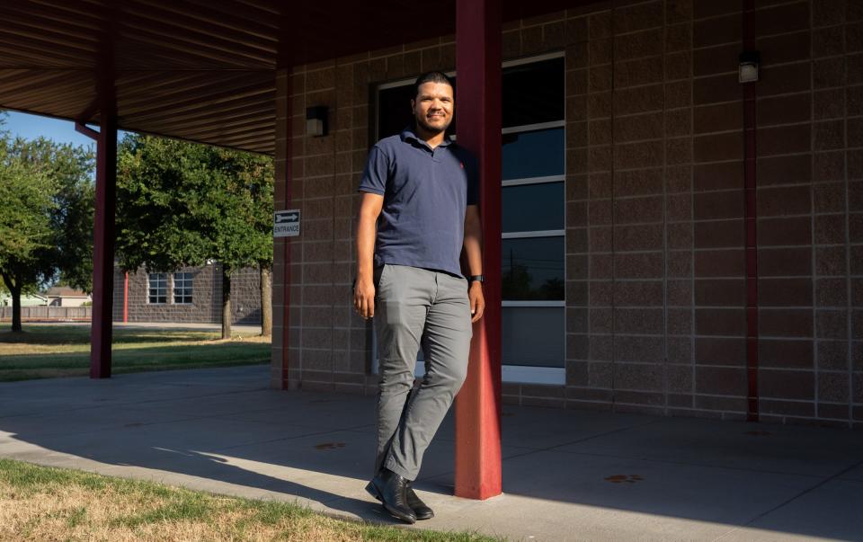 Blake Manor Elementary School sixth grade bilingual education teacher Jaime Palacio stands in front of the school last week. Palacio, from Colombia, is teaching in Manor on a J-1 visa.