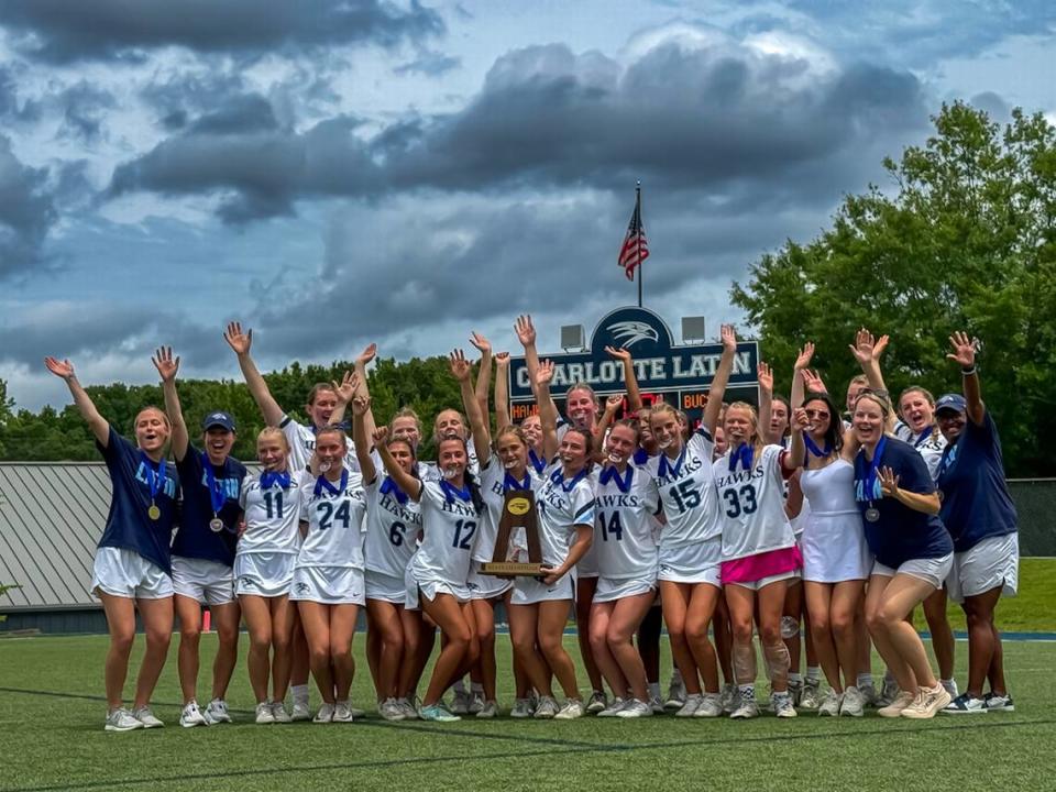 Charlotte Latin girls lacrosse celebrates with all smiles in a United team celebration on the field at the NCISAA lacrosse State playoffs at Charlotte Latin School