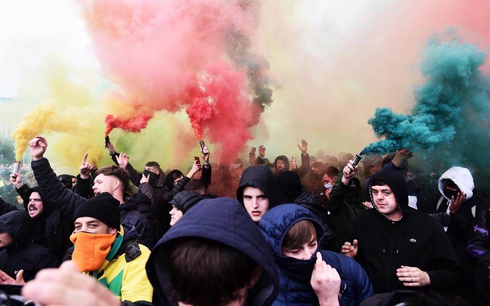 Fans set off smoke flares as they protest outside of Old Trafford on May 13, 2021 in Manchester, England. Police and ground security staff are prepared for a possible demonstration by United supporters against ownership of Manchester United by the Glazer family. - GETTY IMAGES