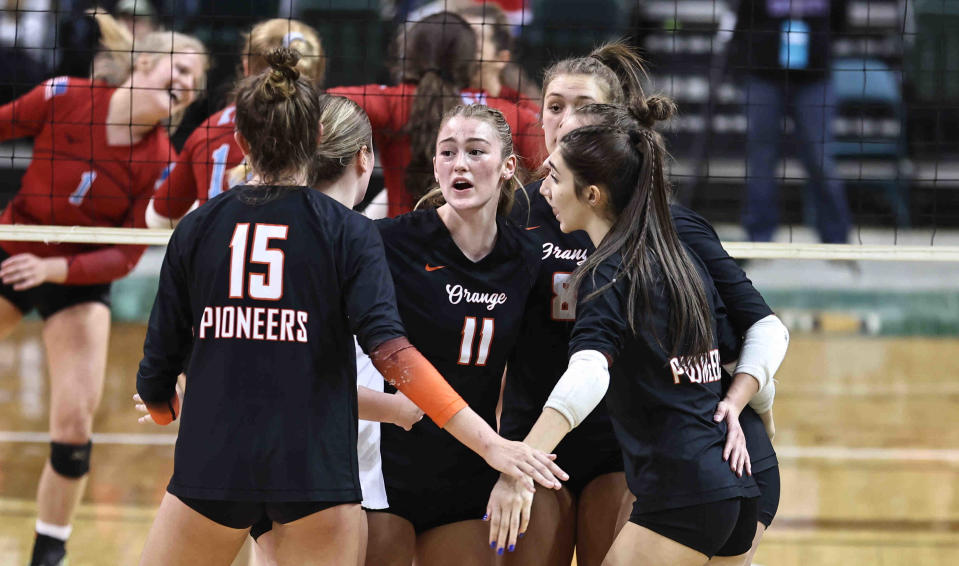 Olentangy Orange players, including Lily Barron (15) and Maddie Cugino (11), gather during the Division I state final against Kings Mills Kings.