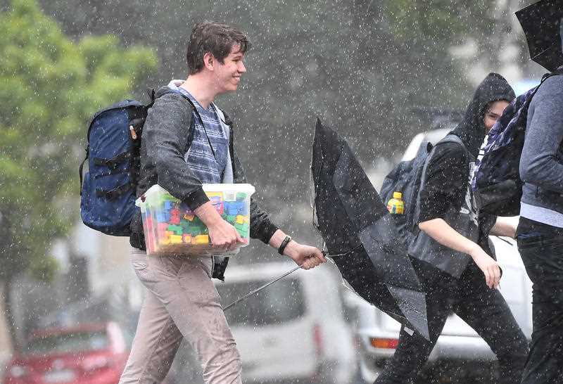 People walk in rainy weather in central Brisbane.
