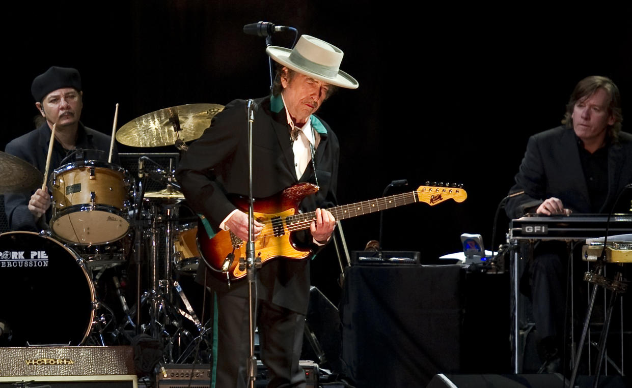 American music legend Bob Dylan (C) performs on stage during his concert in Shanghai on April 8, 2011. Counter-culture legend Bob Dylan, on a tour commemorating 50 years since his first major performance on April 11, 1961 made his long-awaited China debut after finally getting approval to bring his charged songs of protest and struggle to a nation where dissent is muzzled.  AFP PHOTO/Philippe Lopez (Photo credit should read PHILIPPE LOPEZ/AFP via Getty Images)