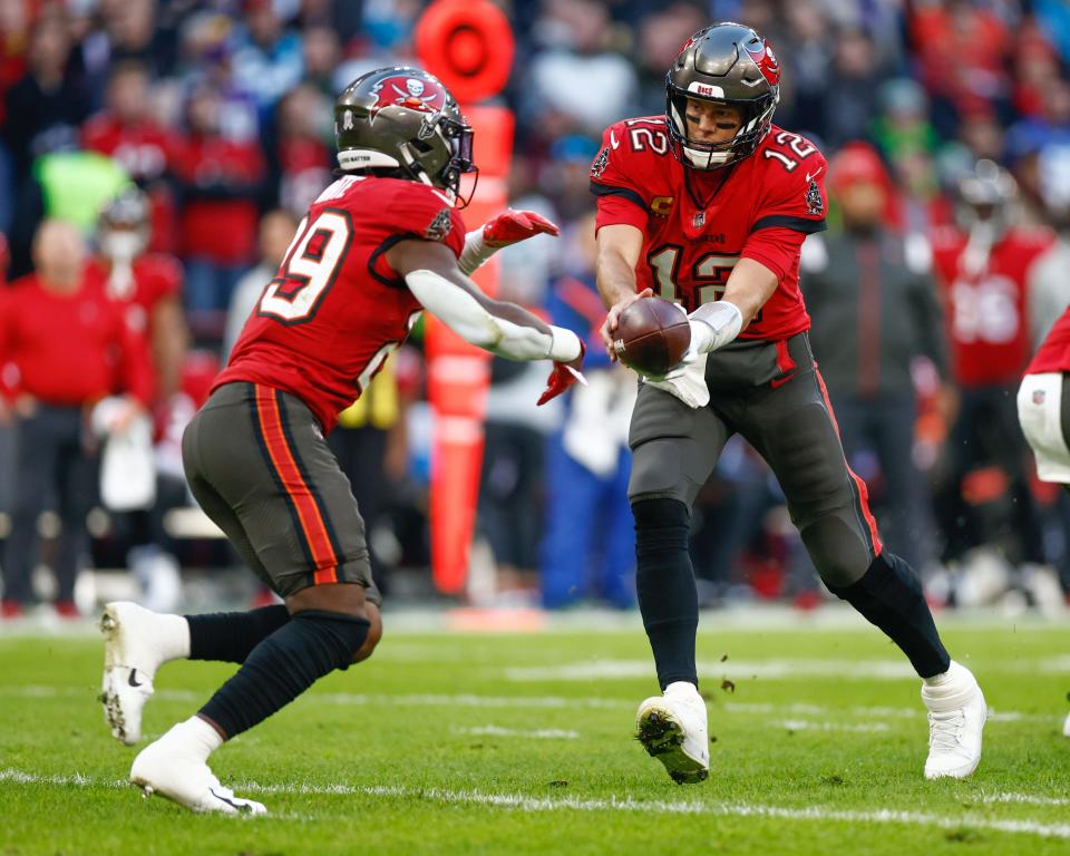 Tampa Bay Buccaneers quarterback Tom Brady (12) looks to hand the ball off to running back Rachaad White.