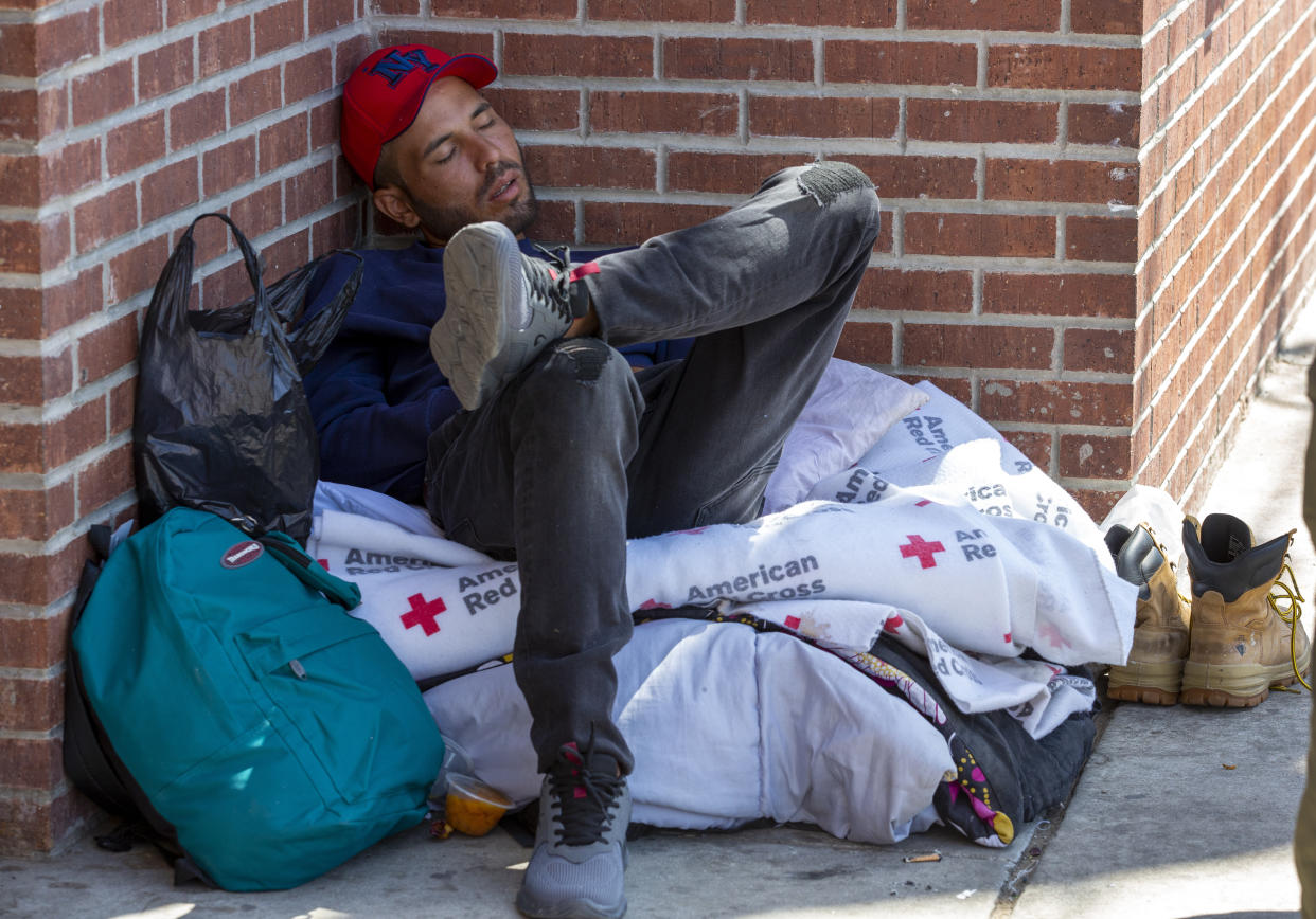 A migrant sleeps outside the Sacred Heart Church shelter in El Paso, Texas, Friday, May 12, 2023. The border between the U.S. and Mexico was relatively calm Friday, offering few signs of the chaos that had been feared following a rush by worried migrants to enter the U.S. before the end of pandemic-related immigration restrictions. (AP Photo/Andres Leighton)