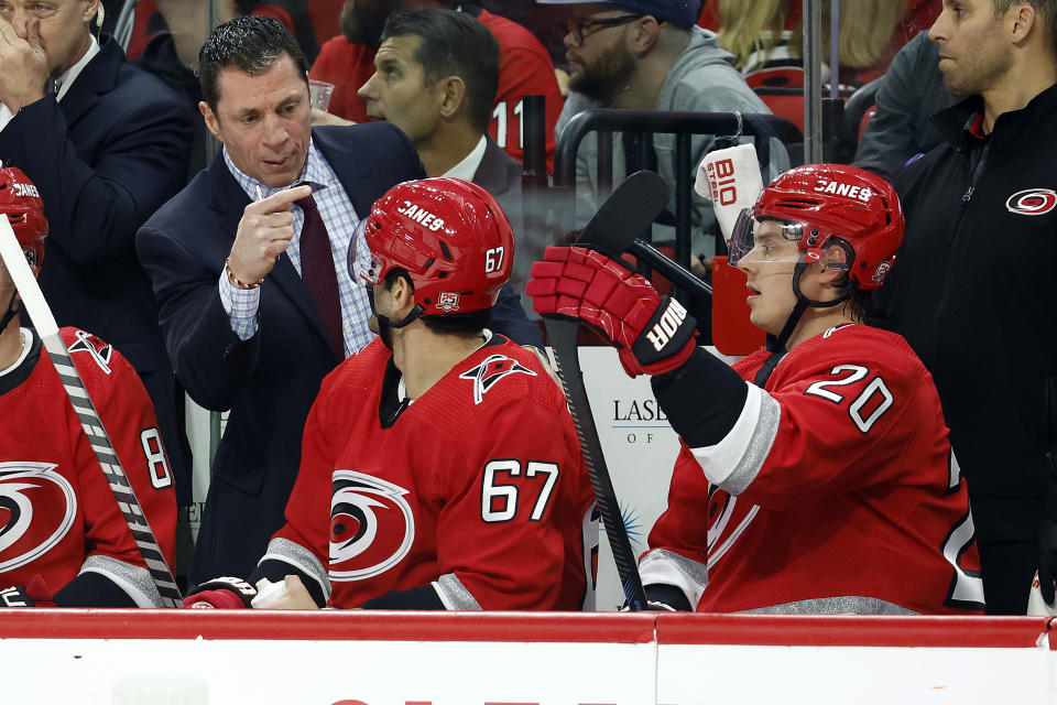 Carolina Hurricanes coach Rod Brind'Amour, left, talks with Max Pacioretty (67) and Sebastian Aho (20) during the second period of the team's NHL hockey game against the Nashville Predators in Raleigh, N.C., Thursday, Jan. 5, 2023. (AP Photo/Karl B DeBlaker)