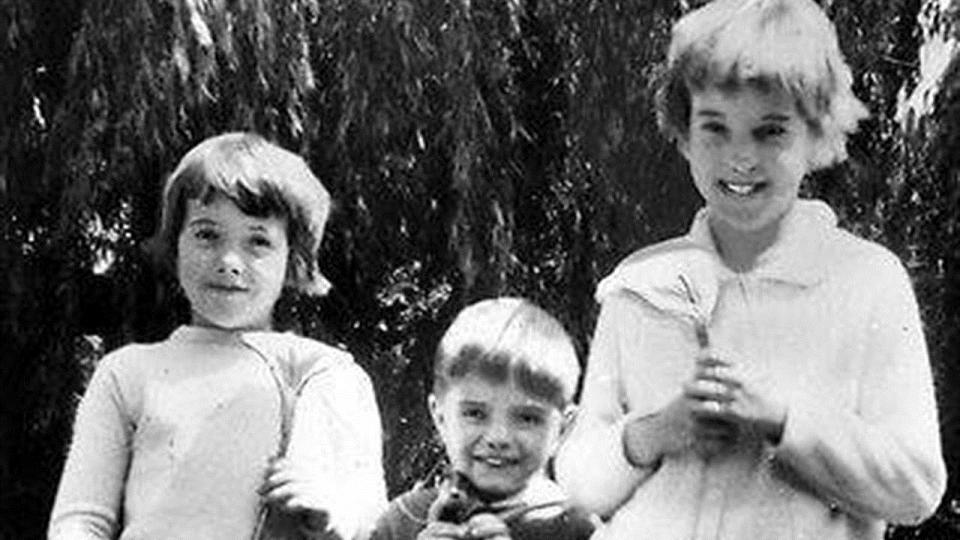 Arnna, 7, Grant, 4, and 9-year-old Jane pictured smiling at the camera. 