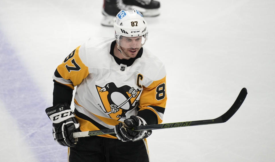 Pittsburgh Penguins center Sidney Crosby reacts after scoring an empty-net goal in the third period of an NHL hockey game against the Colorado Avalanche Wednesday, March 22, 2023, in Denver. (AP Photo/David Zalubowski)