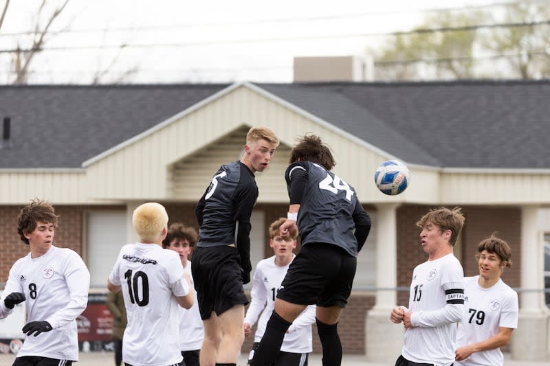 Murray Spartans Bentley Heath (6) and Murray Spartans Kaden Coons (24) jump to receive a corner kick during a game at Murray High School in Murray on Friday, April 5, 2024.