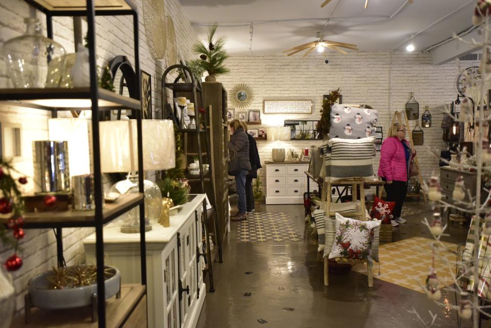 Shoppers browse through holiday inventory for some early Christmas shopping at the home décor boutique the Lazy Llama located at 214 Broadway St. in Marine City on Monday, Dec. 5, 2022. The year has been dominated by headlines about rising costs of inflation and concerns about a future economic recession.