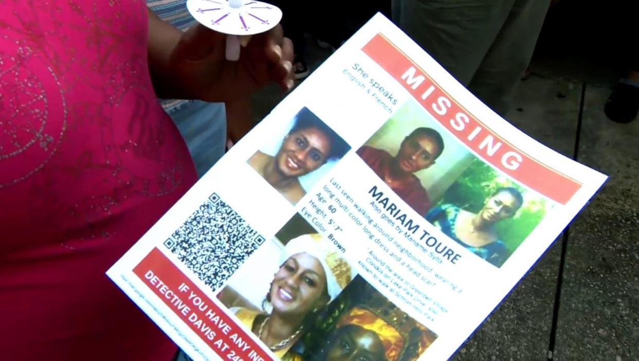 PHOTO: A flyer is handed out at a vigil for missing teacher Mariame Toure Sylla on Aug. 4, 2023. (WJLA)