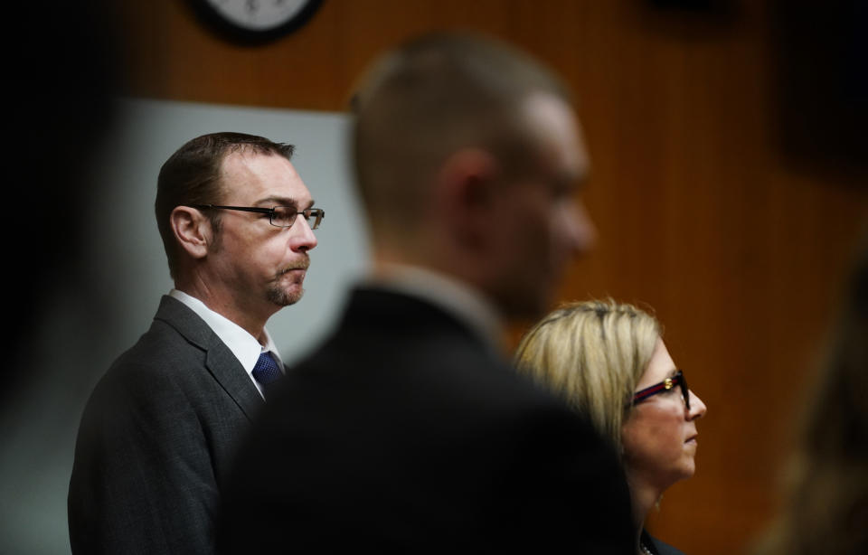 James Crumbley, left, stands with his attorney Mariell Lehman as Oakland County Judge Cheryl Matthews swears in the jury before Crumbley's trial on Thursday, March. 7, 2024 in Pontiac, Mich. James Crumbley, 47, is charged with four counts of involuntary manslaughter, one for each teenager killed by Ethan Crumbley at Oxford High School in 2021. 9Mandi Wright/Detroit Free Press via AP, Pool)