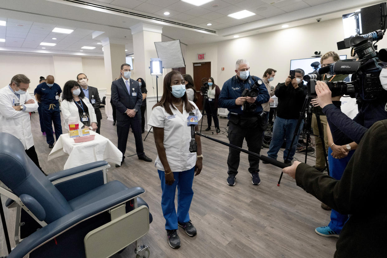 FILE - Nurse Sandra Lindsay, center, gives an interview after she was inoculated with the Pfizer- BioNTech COVID-19 vaccine, Monday, Dec. 14, 2020, at the Jewish Medical Center, in the Queens borough of New York. (AP Photo/Mark Lennihan, Pool, File)