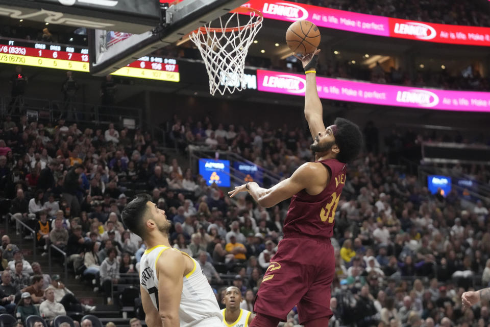 Cleveland Cavaliers center Jarrett Allen (31) shoots as Utah Jazz center Omer Yurtseven (77) looks on in the first half of an NBA basketball game Tuesday, April 2, 2024, in Salt Lake City. (AP Photo/Rick Bowmer)