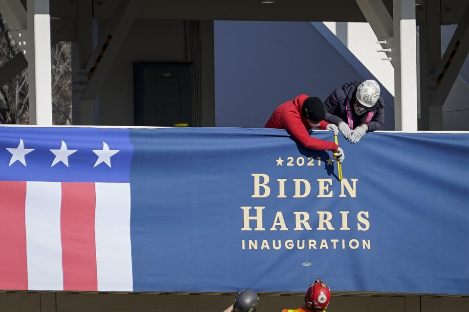 Workers erect "Biden-Harris" bunting on a press riser Thursday along what would have been the inaugural parade route near the White House. (Photo: Drew Angerer via Getty Images)