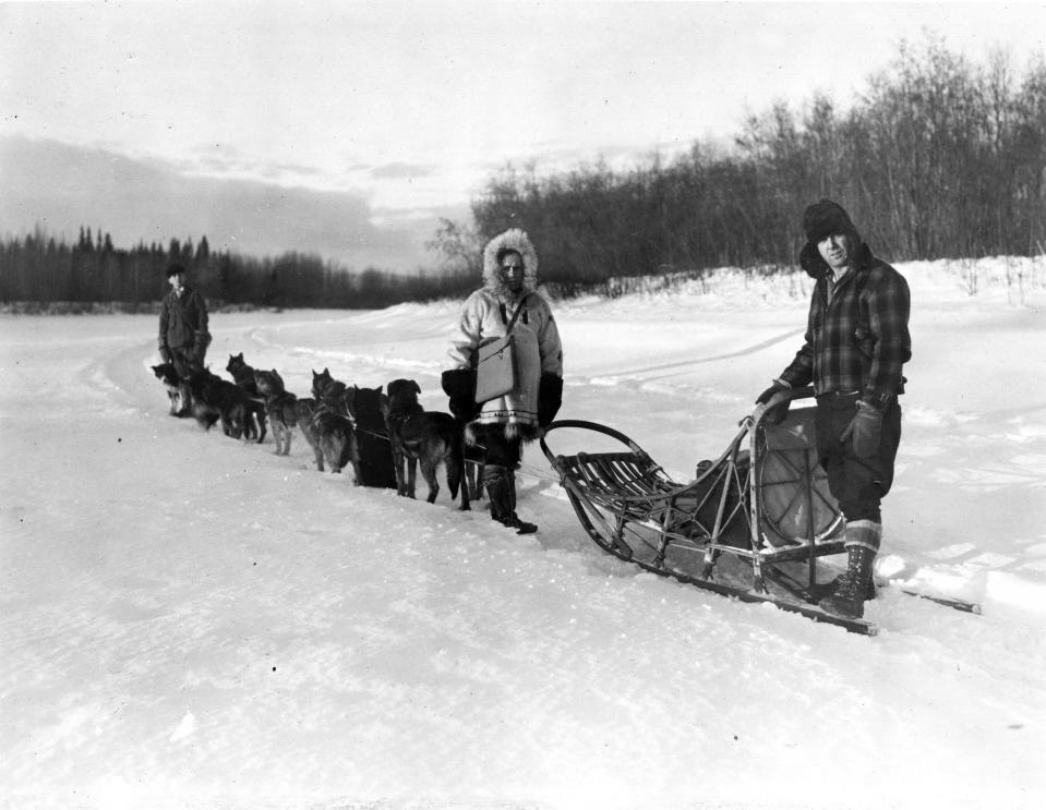 In this undated photo provided by the National Archives at College Park, William F. Arends, center, one of the more than 120,000 enumerators, returns to his dog sled after completing an enumeration near Fairbanks, Alaska for the 1940 Census. At right is musher Mike Agababa. Veiled in secrecy for 72 years because of privacy protections, the 1940 U.S. Census is the first historical federal decennial survey to be made available on the Internet initially rather than on microfilm. (AP Photo/U.S. Bureau of the Census, Dwight Hammack)