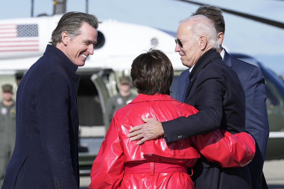 President Joe Biden greets Rep. Anna Eshoo, D-Calif., and California Gov. Gavin Newsom, left, after arriving on Air Force One at Moffett Federal Airfield in Mountain View, Calif., Thursday, Jan 19, 2023. (AP Photo/Susan Walsh)