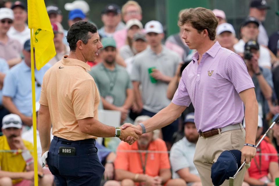 Apr 4, 2023; Augusta, Georgia, USA; Rory McIlroy shakes hands with Gordon Sargent on the ninth green during a practice round for The Masters golf tournament at Augusta National Golf Club. Mandatory Credit: Michael Madrid-USA TODAY Network