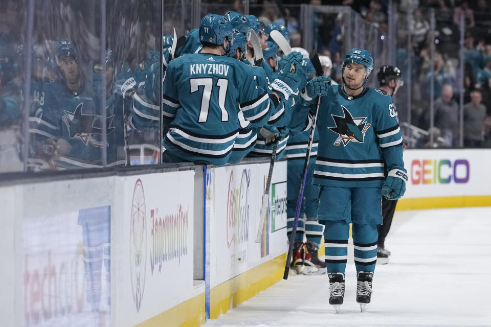 San Jose Sharks right wing Kevin Labanc, right, celebrates with teammates after scoring a goal against the New York Islanders during the first period of an NHL hockey game in San Jose, Calif., Saturday, March 18, 2023. (AP Photo/Godofredo A. Vásquez)
