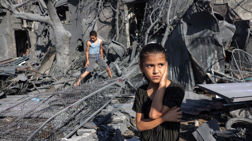 A girl looks on as she stands by the rubble outside a building that was hit by Israeli bombardment in Rafah in the southern Gaza Strip, October 31, 2023. - Mohammed Abed/AFP/Getty Images