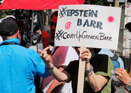 A protester holds up a sign outside the courthouse ahead of a bail hearing in U.S. financier Jeffrey Epstein's sex trafficking case in New York City